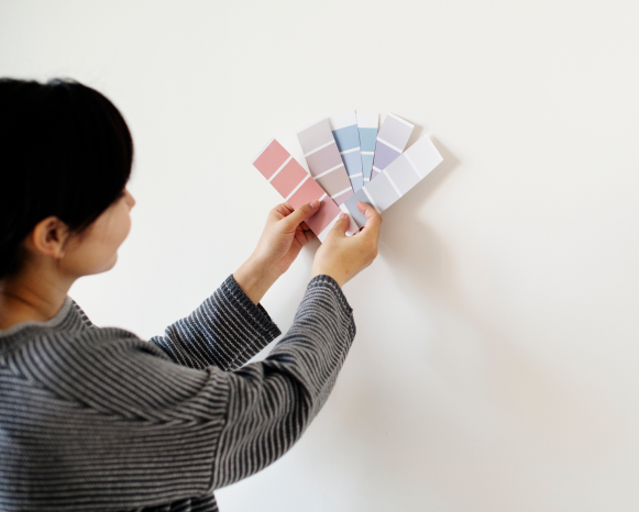 asian-woman-choosing-wall-color 1