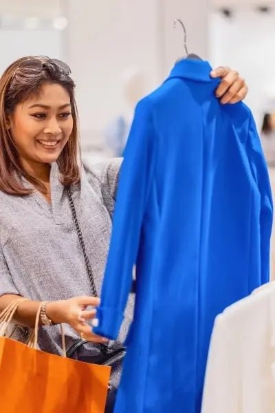 happy-asian-woman-choosing-clothes